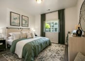 Thumbnail 21 of 38 - a bedroom with a green and white bed and a window