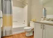 Thumbnail 14 of 30 - A bathroom with a toilet, sink, and shower.
