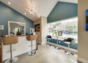 Thumbnail 19 of 30 - A reception area with a white counter and brown chairs.