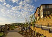 Thumbnail 26 of 28 - A walkway leads to a building with a mountain in the background.