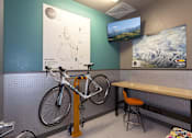 Thumbnail 15 of 28 - A bike is chained to a stand in a room.