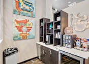 Thumbnail 14 of 28 - A diner themed room with a trash can and a fridge.