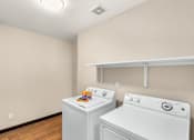 Thumbnail 12 of 30 - A small laundry room with a washer and dryer.