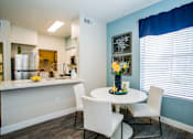 Thumbnail 6 of 44 - A kitchen with a table and chairs.