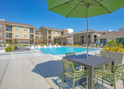 Thumbnail 35 of 38 - our apartments feature a pool and patio with a table and chairs