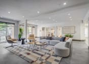 Thumbnail 9 of 25 - leasing lobby with couches and chairs and a rug