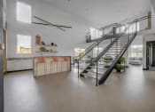 Thumbnail 15 of 25 - a staircase in a the club room with a kitchen and open space