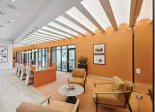 Thumbnail 18 of 30 - a living room with orange walls and chairs and a table