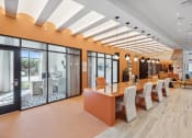 Thumbnail 19 of 30 - a conference room with orange walls and a table with chairs