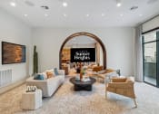 Thumbnail 23 of 30 - a living room with couches and chairs and an arched doorway