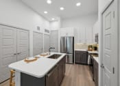Thumbnail 1 of 30 - a large kitchen with white cabinets and a white counter top