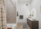 Thumbnail 13 of 30 - a bathroom with a shower and a sink and a mirror