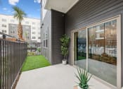 Thumbnail 17 of 30 - a patio with a plant and a glass door