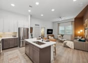 Thumbnail 5 of 30 - an open kitchen and living room with a sink and a refrigerator