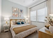 Thumbnail 12 of 30 - a bedroom with a large bed and a window