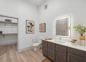 Thumbnail 14 of 30 - a bathroom with a mirror and a toilet and a sink