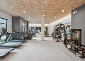 Thumbnail 28 of 30 - a gym with treadmills and other exercise equipment and a large window
