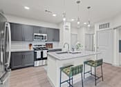 Thumbnail 17 of 20 - A modern kitchen with a white island and green bar stools.