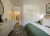 Thumbnail 25 of 38 - a bedroom with a bed and a dresser
