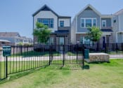 Thumbnail 25 of 31 - a house with a wrought iron fence in front of it