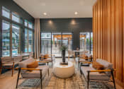 Thumbnail 6 of 28 - a lounge area with chairs and tables and windows