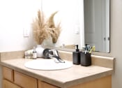 Thumbnail 27 of 37 - a bathroom sink with a large mirror above it