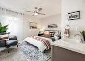 Thumbnail 7 of 48 - Bedroom with en suite sink and ceiling fan at Canyon Creek Apartments, Wilsonville, OR