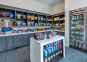 Thumbnail 5 of 29 - a store with a counter filled with food and a refrigerator
