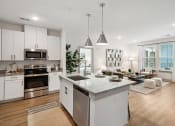 Thumbnail 15 of 29 - an open kitchen and living room with a large island