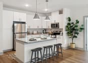 Thumbnail 1 of 29 - an open kitchen with a center island with three stools