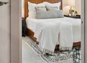 Thumbnail 3 of 29 - a bedroom with a bed with a white comforter and pillows