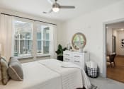 Thumbnail 20 of 29 - a bedroom with a bed and a large window