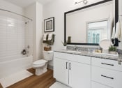 Thumbnail 24 of 29 - a bathroom with a large mirror and a toilet and a bath tub