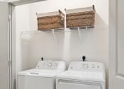 Thumbnail 27 of 29 - a washer and dryer in a laundry room with two baskets on the wall