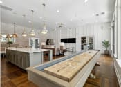 Thumbnail 8 of 29 - a large kitchen with a bar and a living room