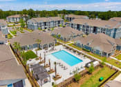 Thumbnail 4 of 29 - an aerial view of an apartment complex with a swimming pool