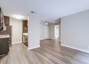 Thumbnail 6 of 51 - A kitchen with a refrigerator and a dining table is visible.