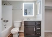 Thumbnail 15 of 51 - A white toilet sits next to a sink in a bathroom.