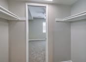 Thumbnail 18 of 51 - A white closet with a mirror and a fan.
