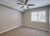 Thumbnail 13 of 51 - A room with a ceiling fan and a window with blinds.