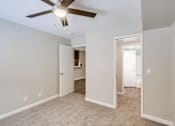 Thumbnail 11 of 51 - A room with a ceiling fan and two open doors.