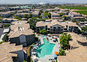 Thumbnail 43 of 48 - A large swimming pool is surrounded by apartment buildings.