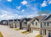 Thumbnail 30 of 31 - a row of houses in front of a blue sky