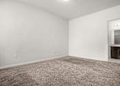 Thumbnail 12 of 29 - A room with a carpeted floor and a window.