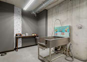 Thumbnail 21 of 30 - A stainless steel table with a sign on the wall behind it.