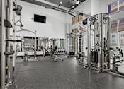 Thumbnail 15 of 30 - A black and white image of a gym with various exercise equipment.