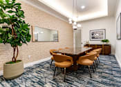 Thumbnail 23 of 57 - A conference room with a long table and chairs.