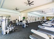 Thumbnail 45 of 57 - A gym with a variety of equipment including treadmills, weights, and exercise machines.