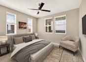 Thumbnail 11 of 33 - A bedroom with a large bed, a chair, and a ceiling fan.
