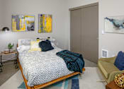 Thumbnail 8 of 30 - A bedroom with a bed and chair